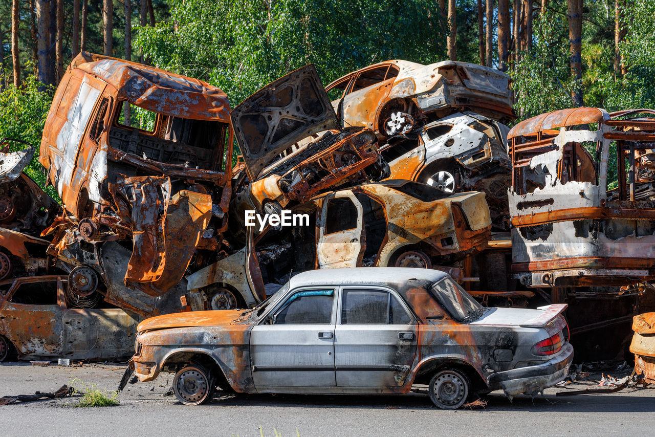 Skeletons of burned cars piled up after the expulsion of russian invaders near the city of irpin.