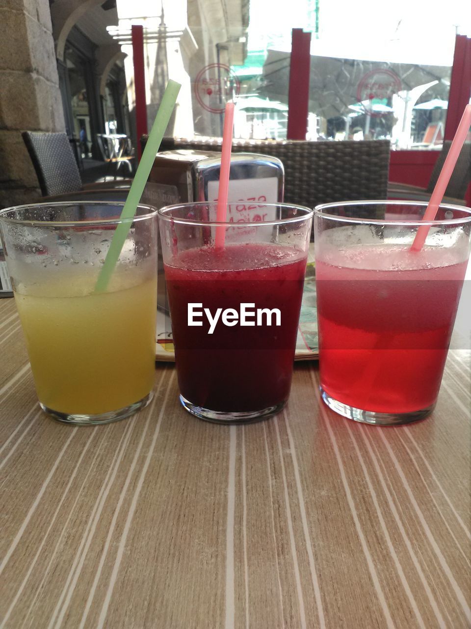 TEA IN GLASS ON TABLE IN FRONT OF GLASSES