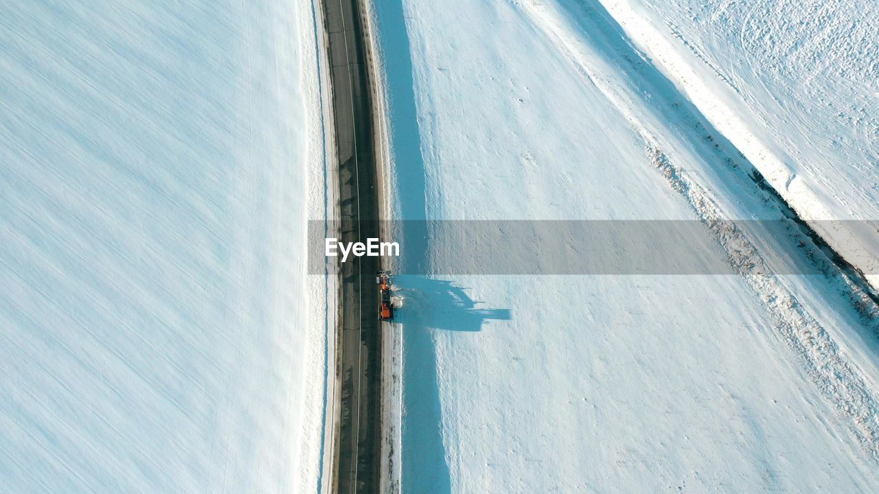 high angle view of people skiing on snow covered landscape