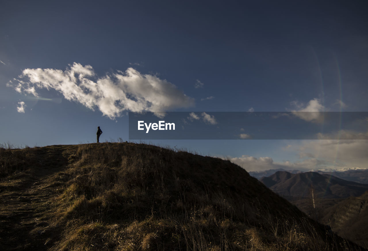 Scenic view of landscape against cloudy sky