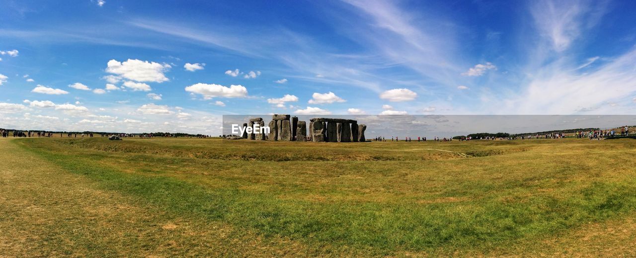 Panoramic of stonehenge on field against sky
