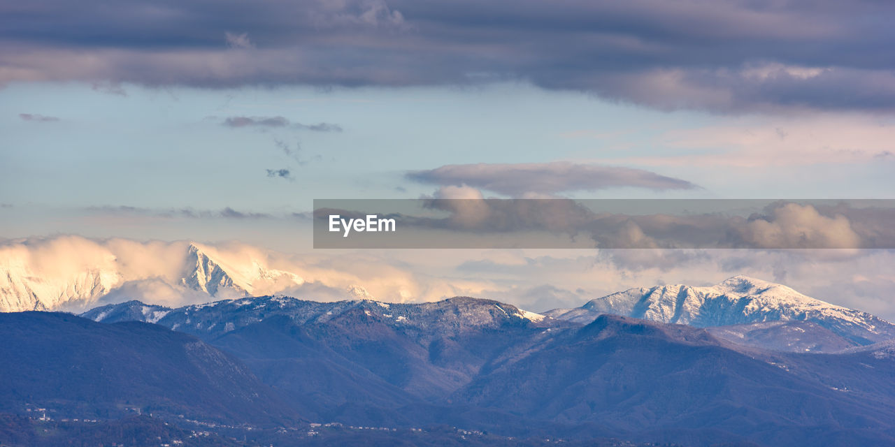 Scenic view of snowcapped mountains against sky