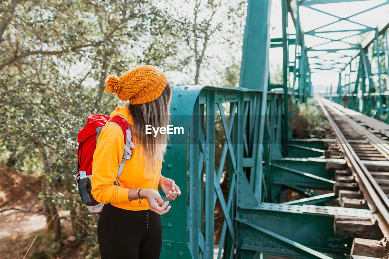 Woman exploring trails and an old iron railroad bridge