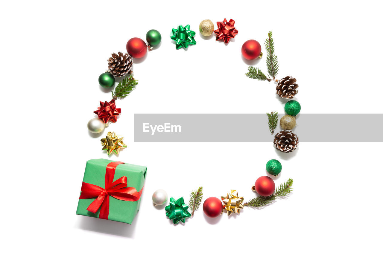 Directly above shot of christmas decorations with gift on white background