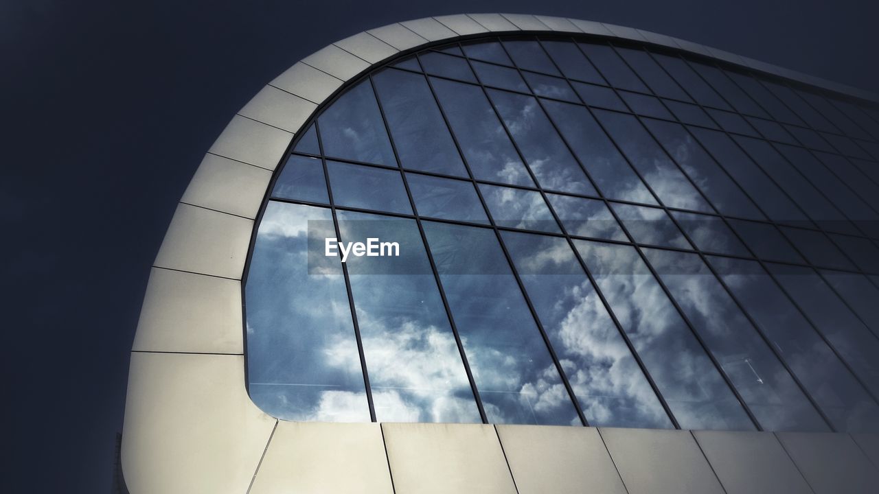 Reflection of sky and clouds on glass building