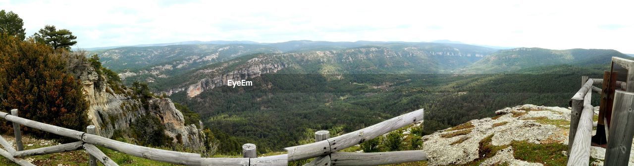 Scenic view of mountains against cloudy sky