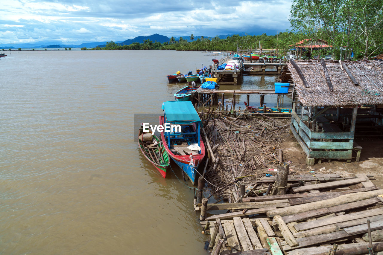 Boat moored in river against sky