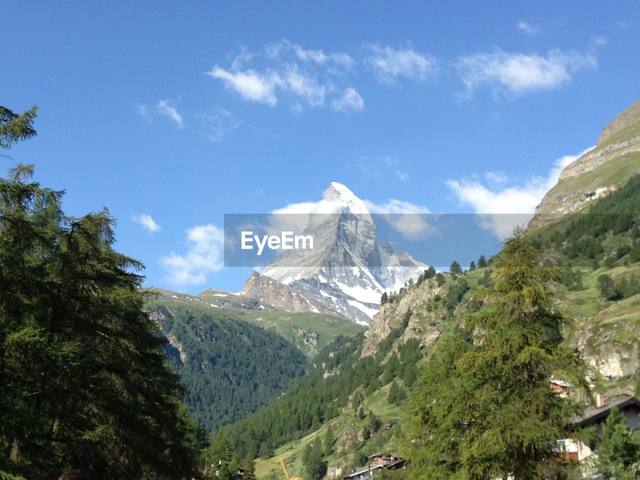 Scenic view of mountains against blue sky