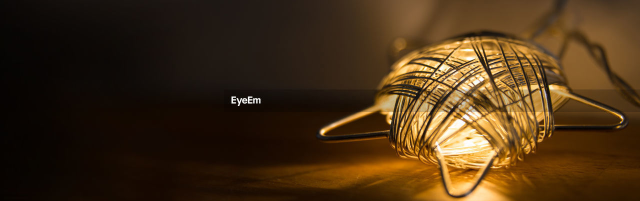 Close-up of an electric garland star form on a wooden table