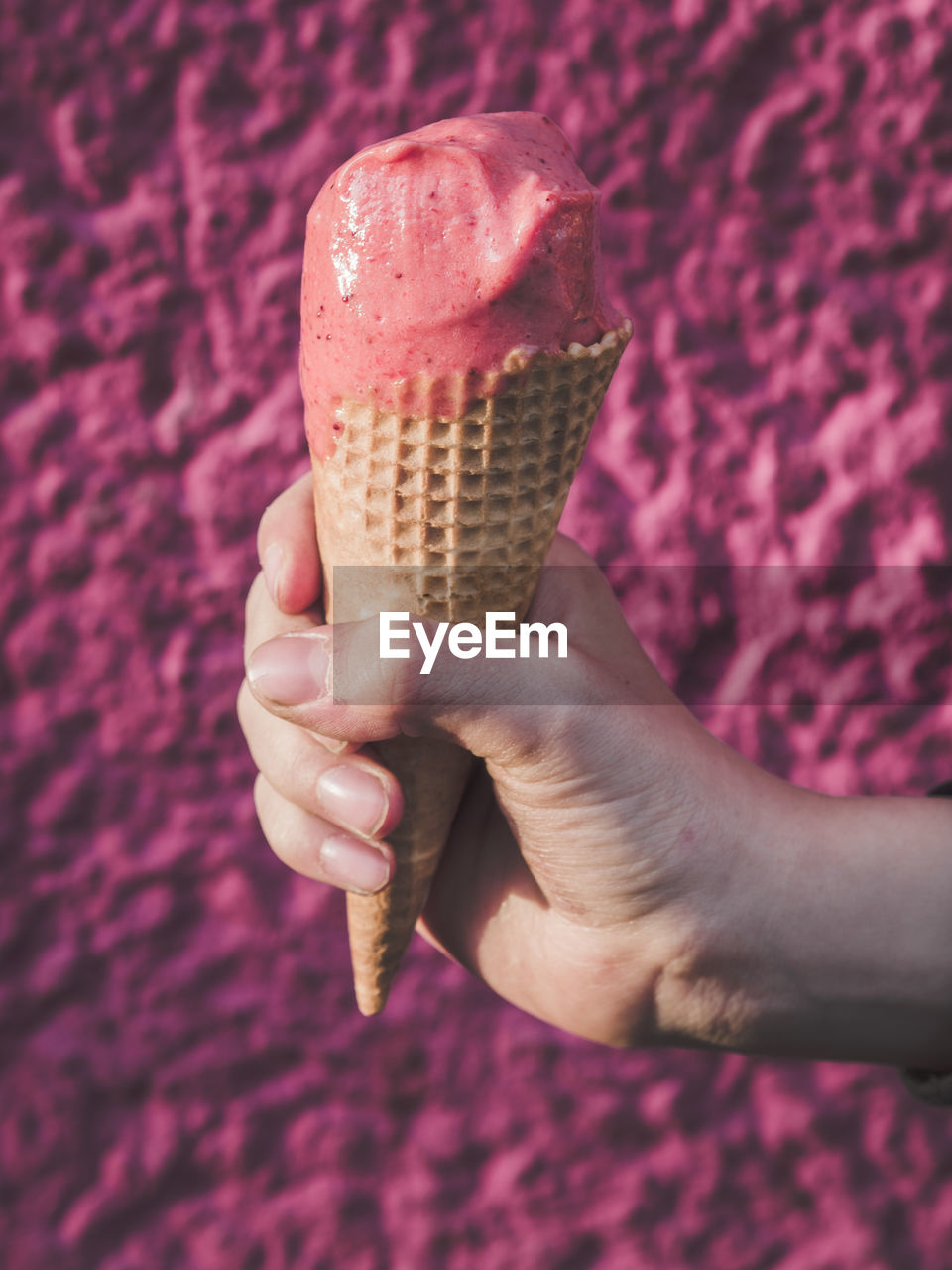 Close-up of hand holding ice cream