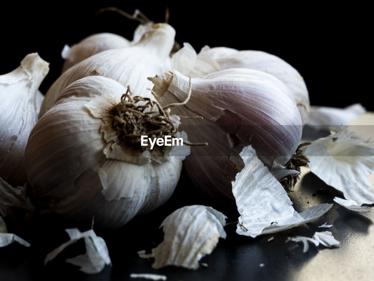 Few garlic heads on dark background