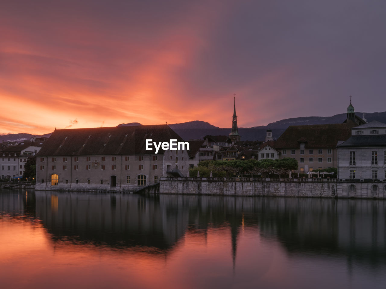 TOWN BY RIVER AGAINST SKY