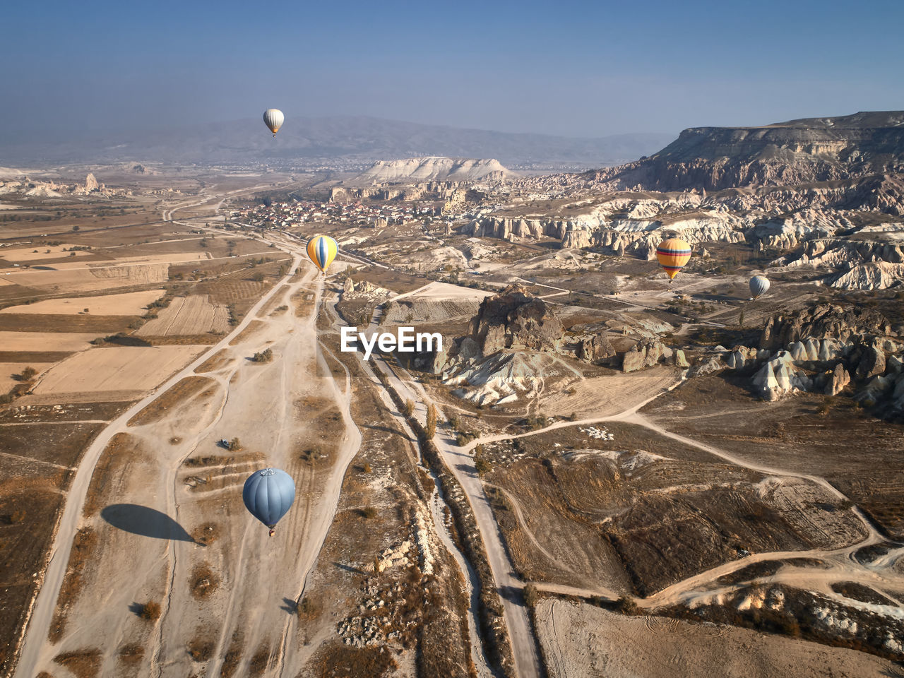 Aerial view of hot air balloon over landscape against sky