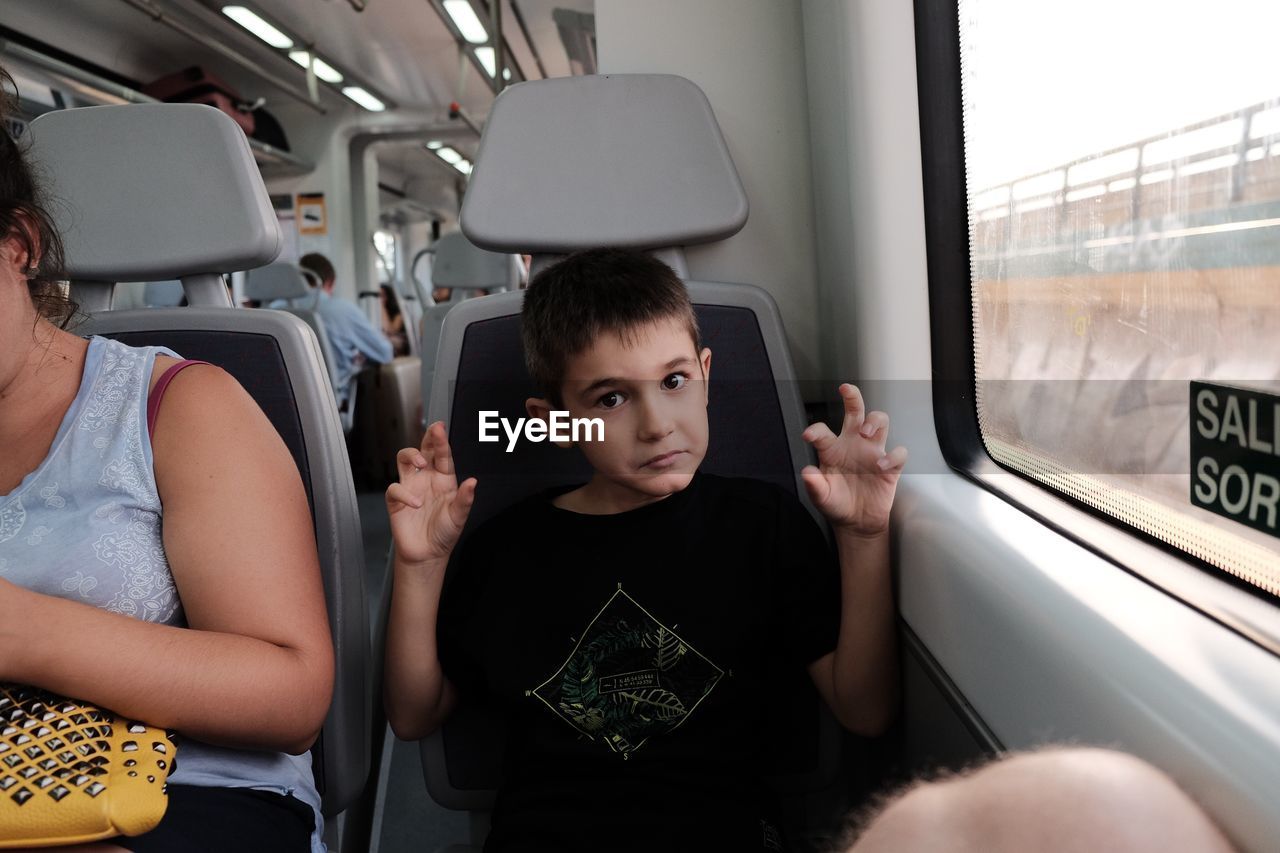 Portrait of cute boy sitting in bus