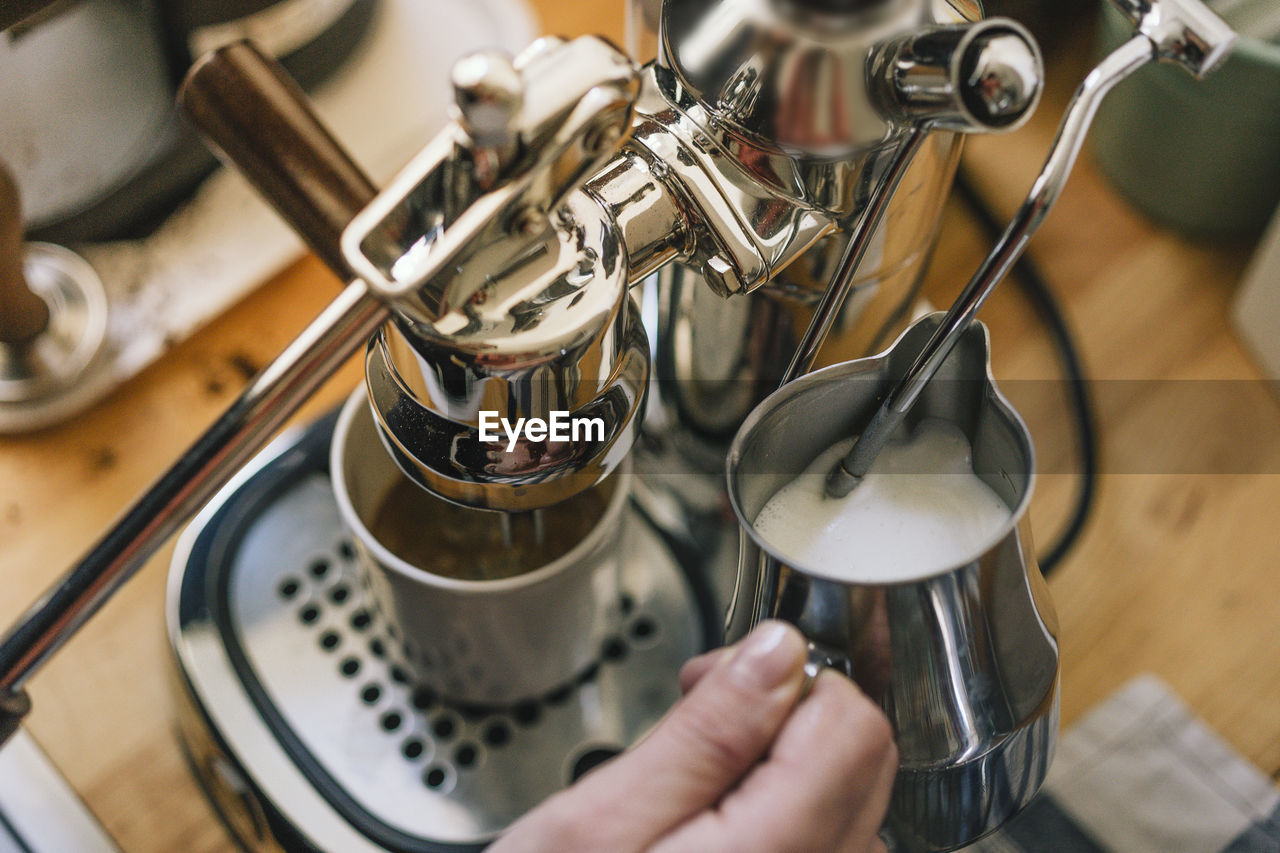 HAND HOLDING COFFEE CUP