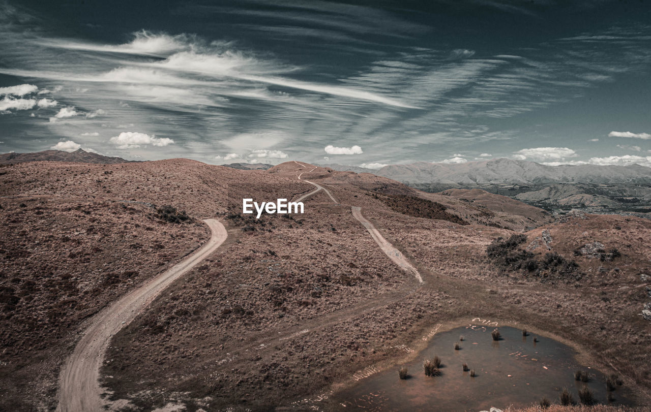 High angle view of road amidst land against sky