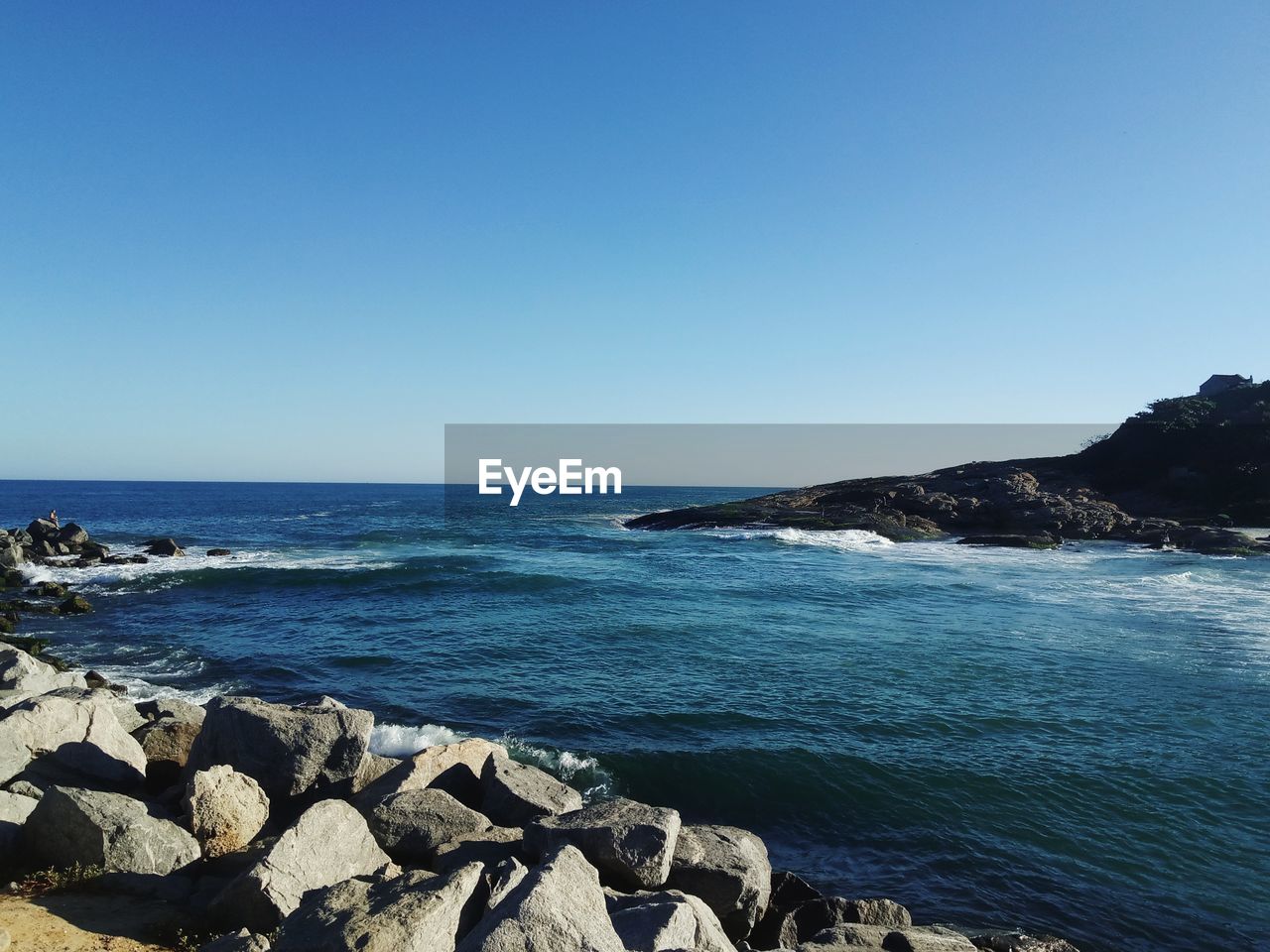 Scenic view of sea against clear blue sky