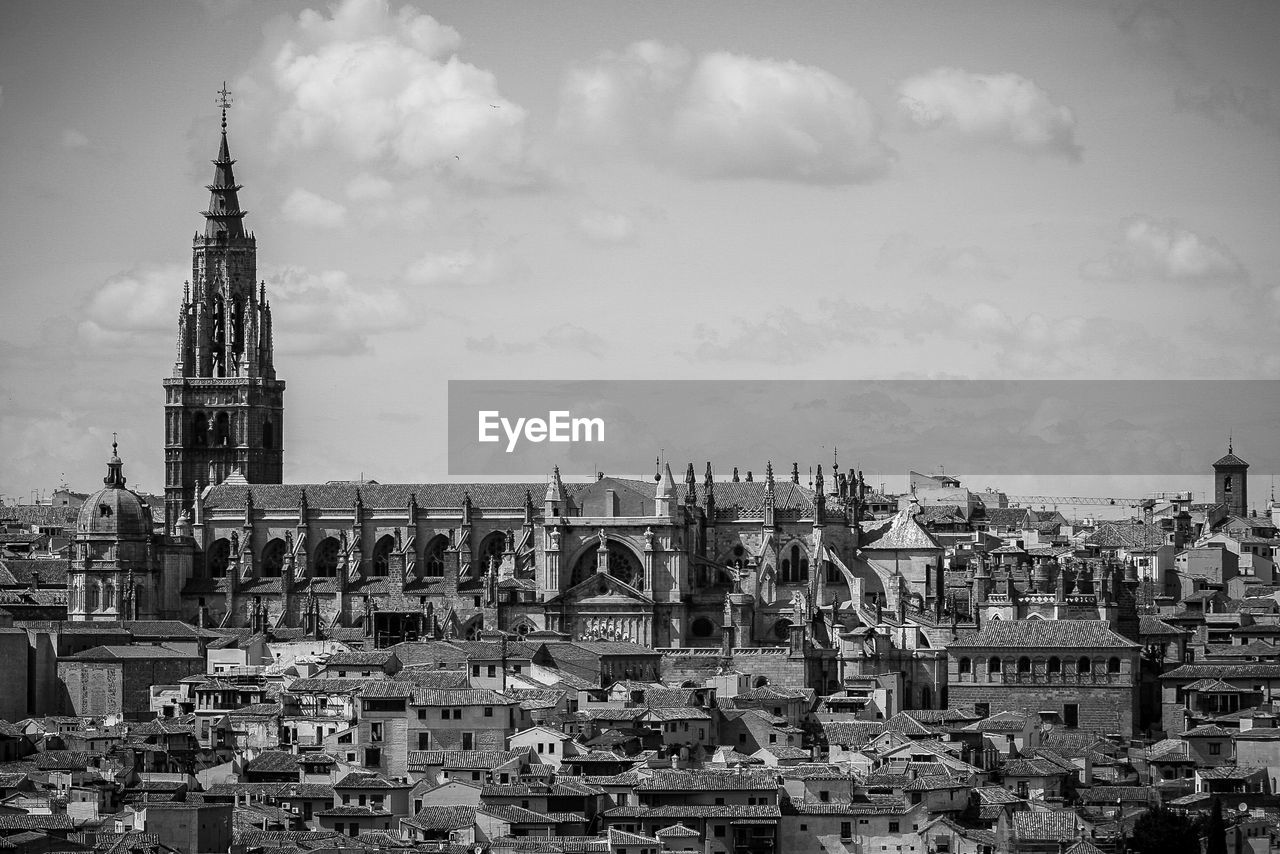 Townscape by cathedral against sky