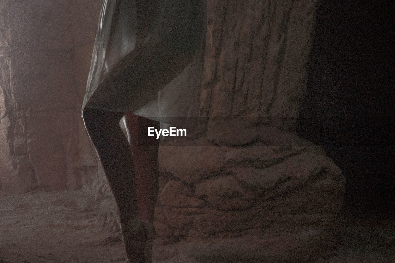 CLOSE-UP OF WOMAN STANDING ON ROCK