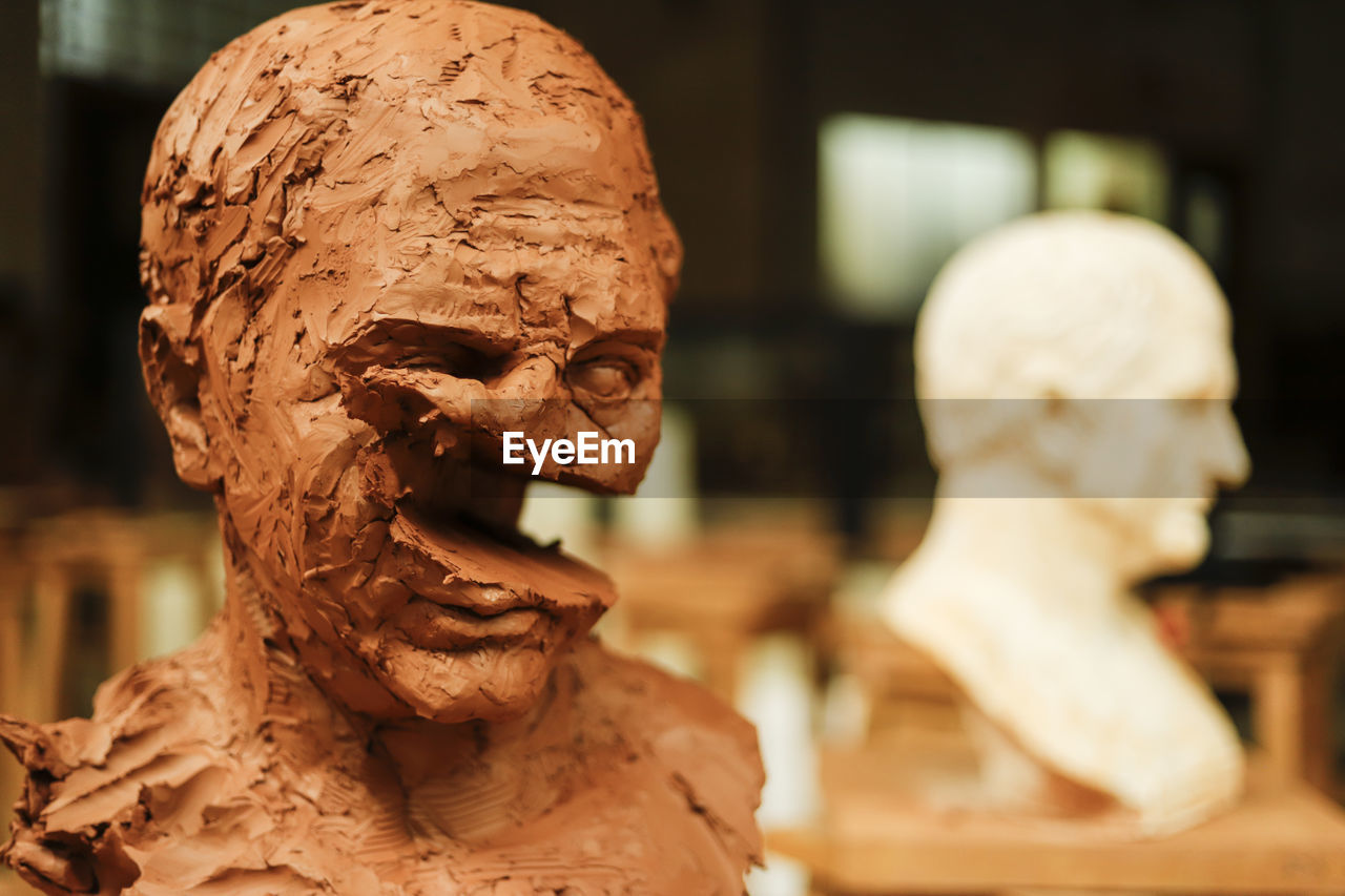 Destructed clay head in art studio