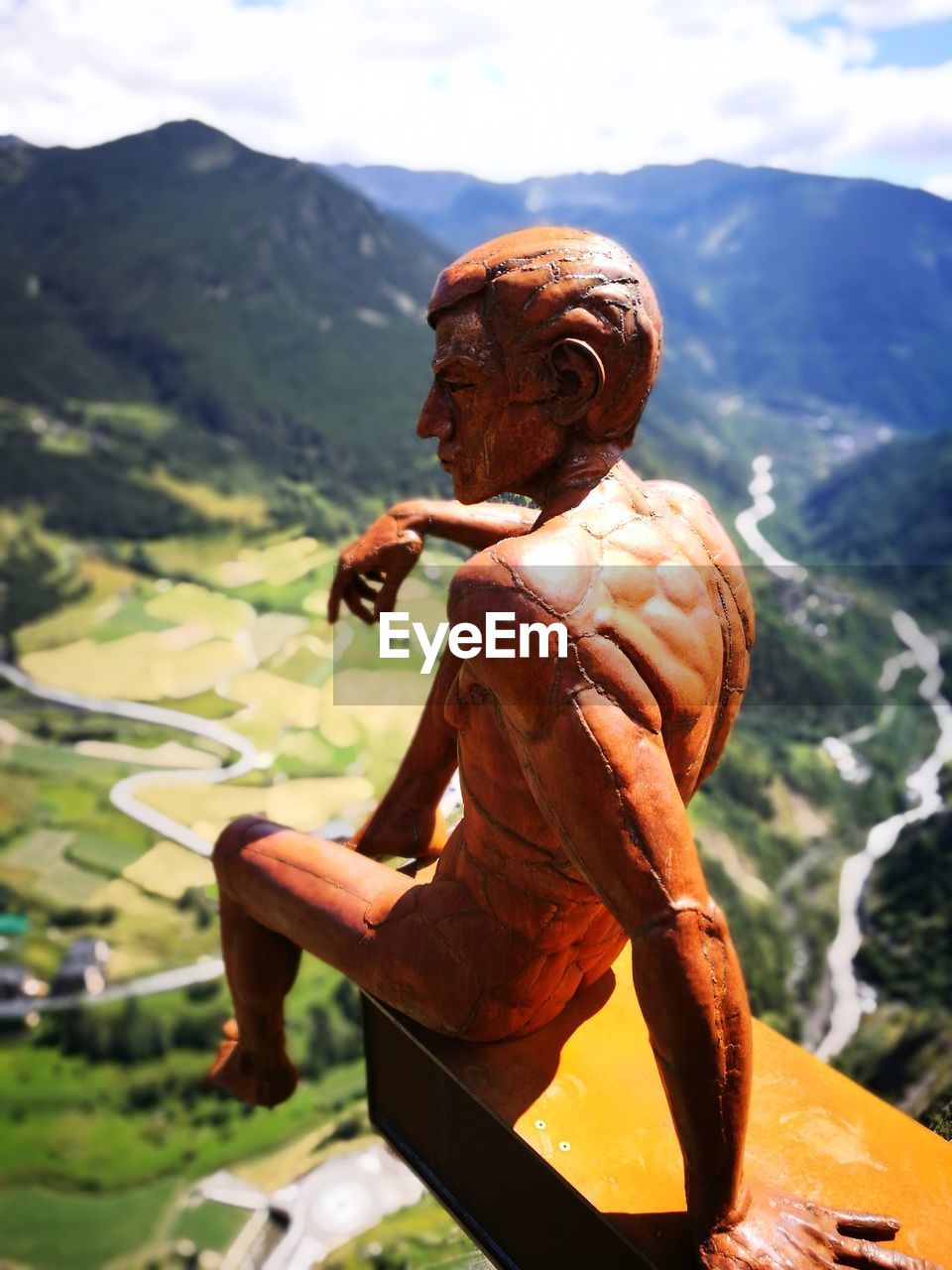 Close-up of statue overlooking landscape