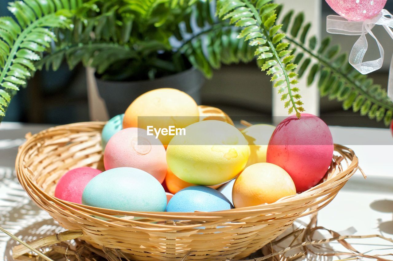 Close-up of multi colored easter eggs in basket at a festive brunch