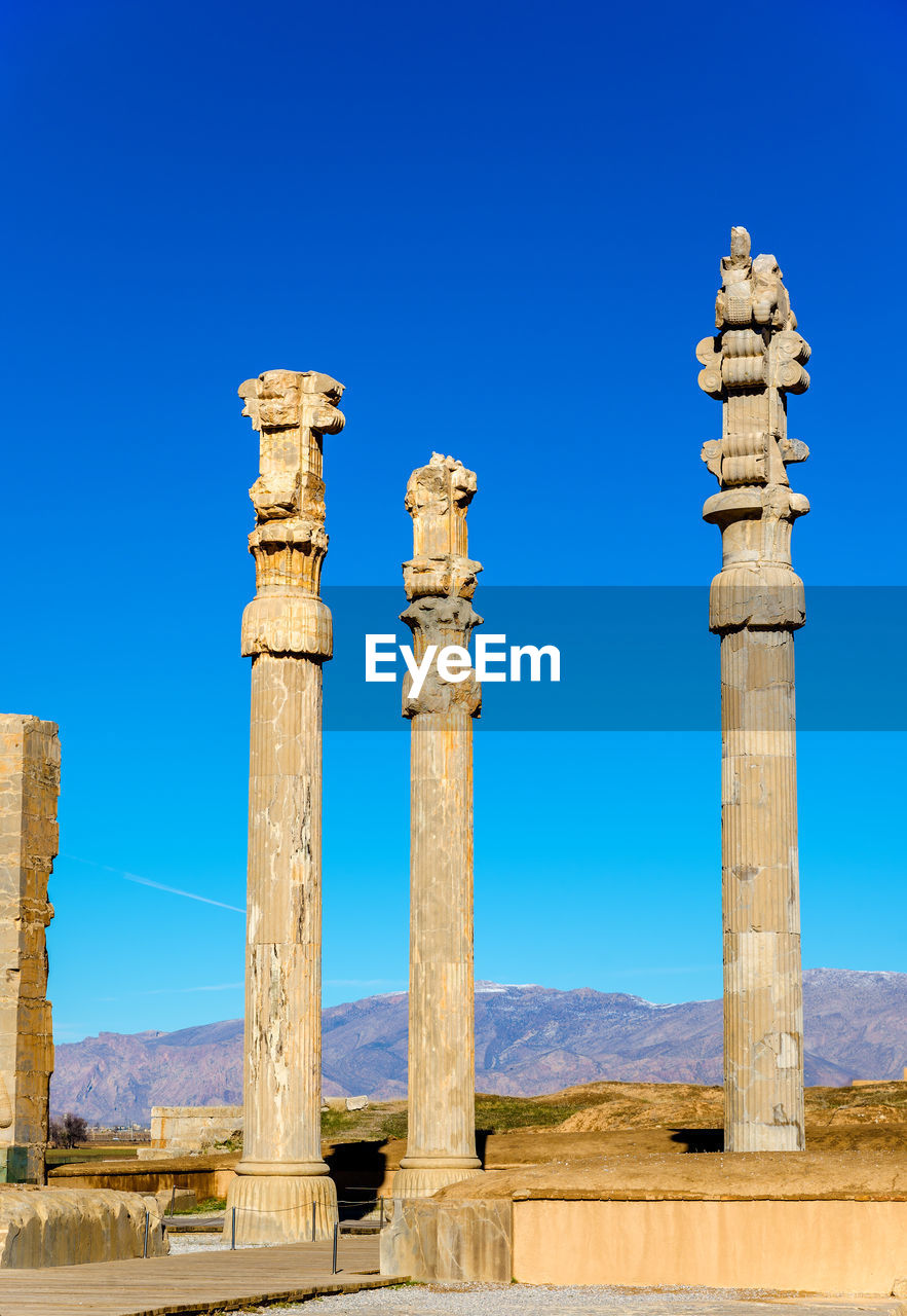 LOW ANGLE VIEW OF OLD RUINS AGAINST BLUE SKY