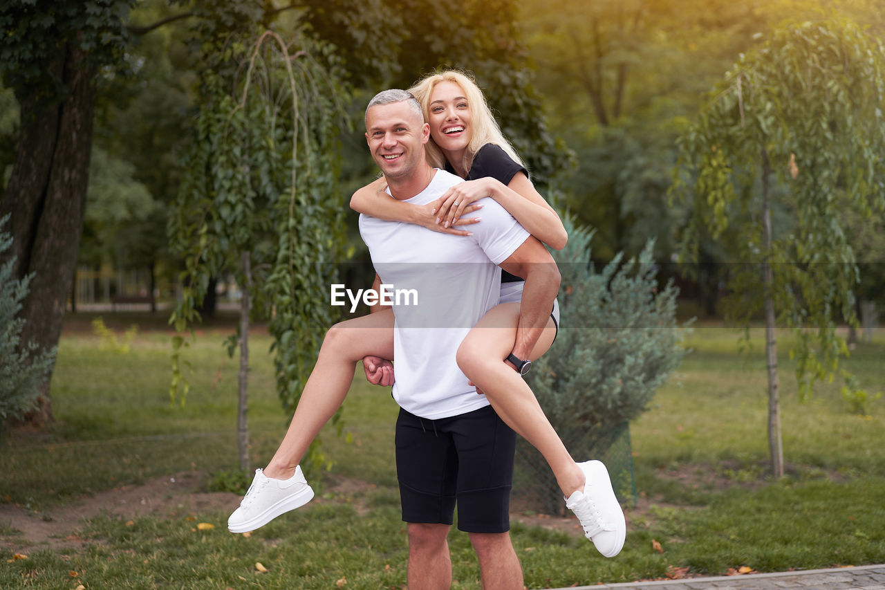 Portrait of smiling couple standing in park