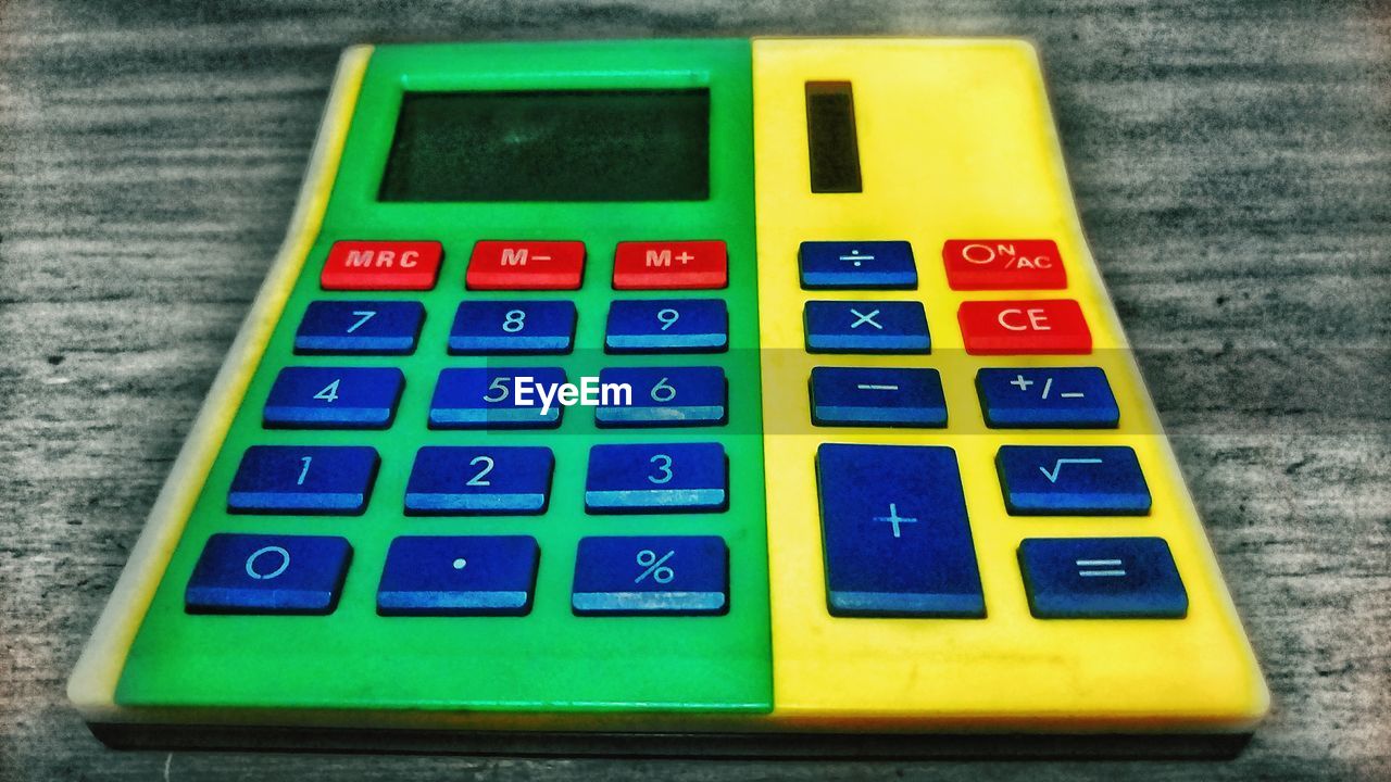 CLOSE-UP OF YELLOW TOY ON TABLE