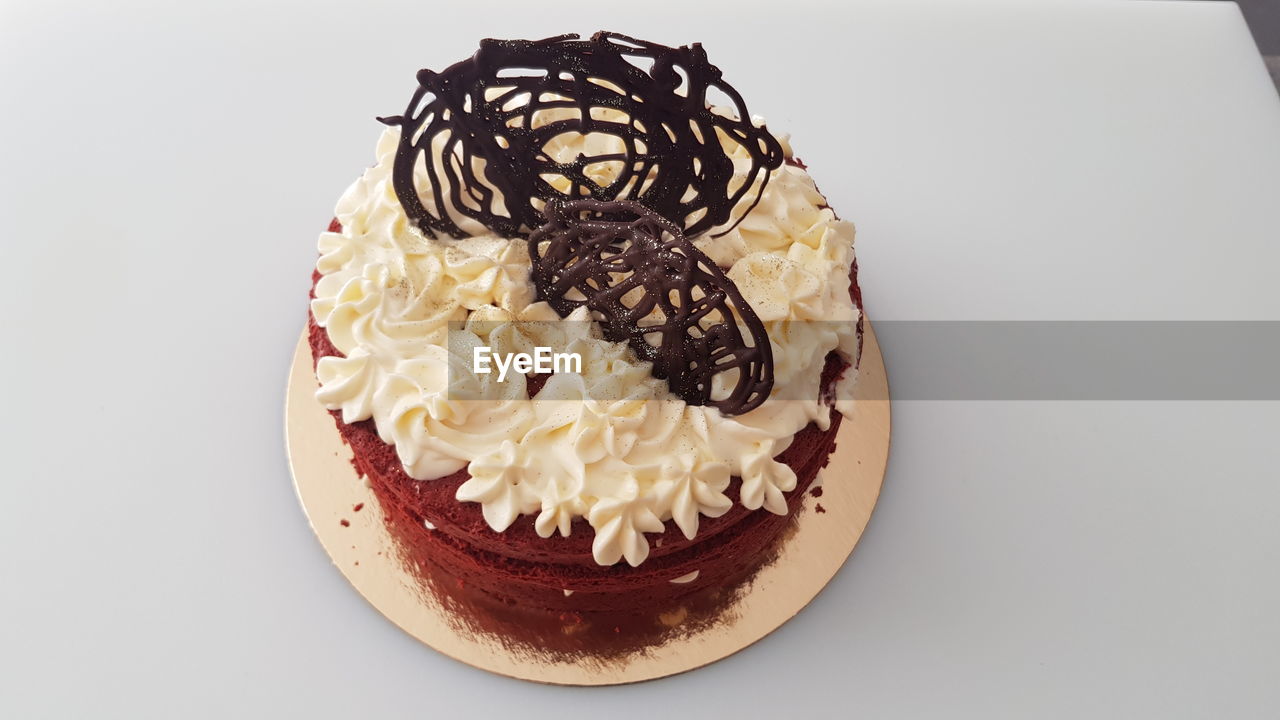 food and drink, food, cake, sweet food, dessert, sweet, birthday cake, icing, temptation, baked, indoors, freshness, cupcake, unhealthy eating, chocolate, no people, cream, chocolate cake, still life, plate, whipped, cake decorating, close-up, serving size, table