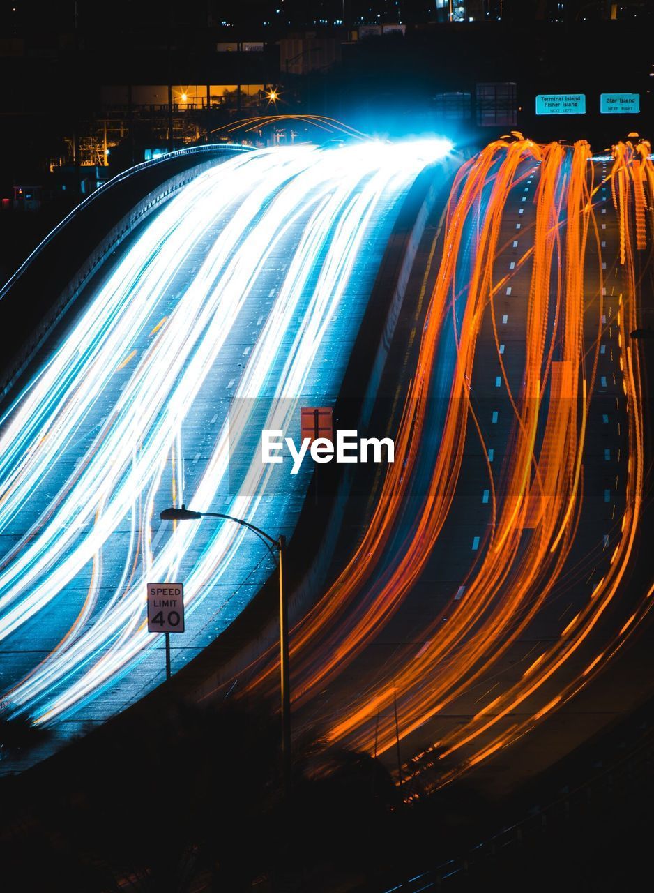 Light trails on road in city at night