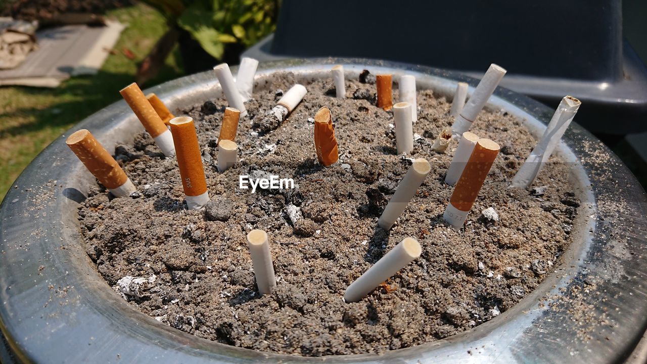 CLOSE-UP OF SMOKING CIGARETTE ON TABLE