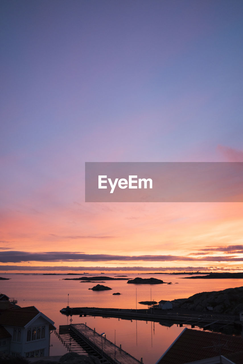 Scenic view of sea against romantic sky at sunset