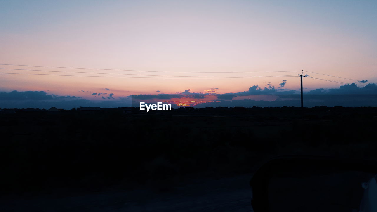 Silhouette landscape against sky during sunset