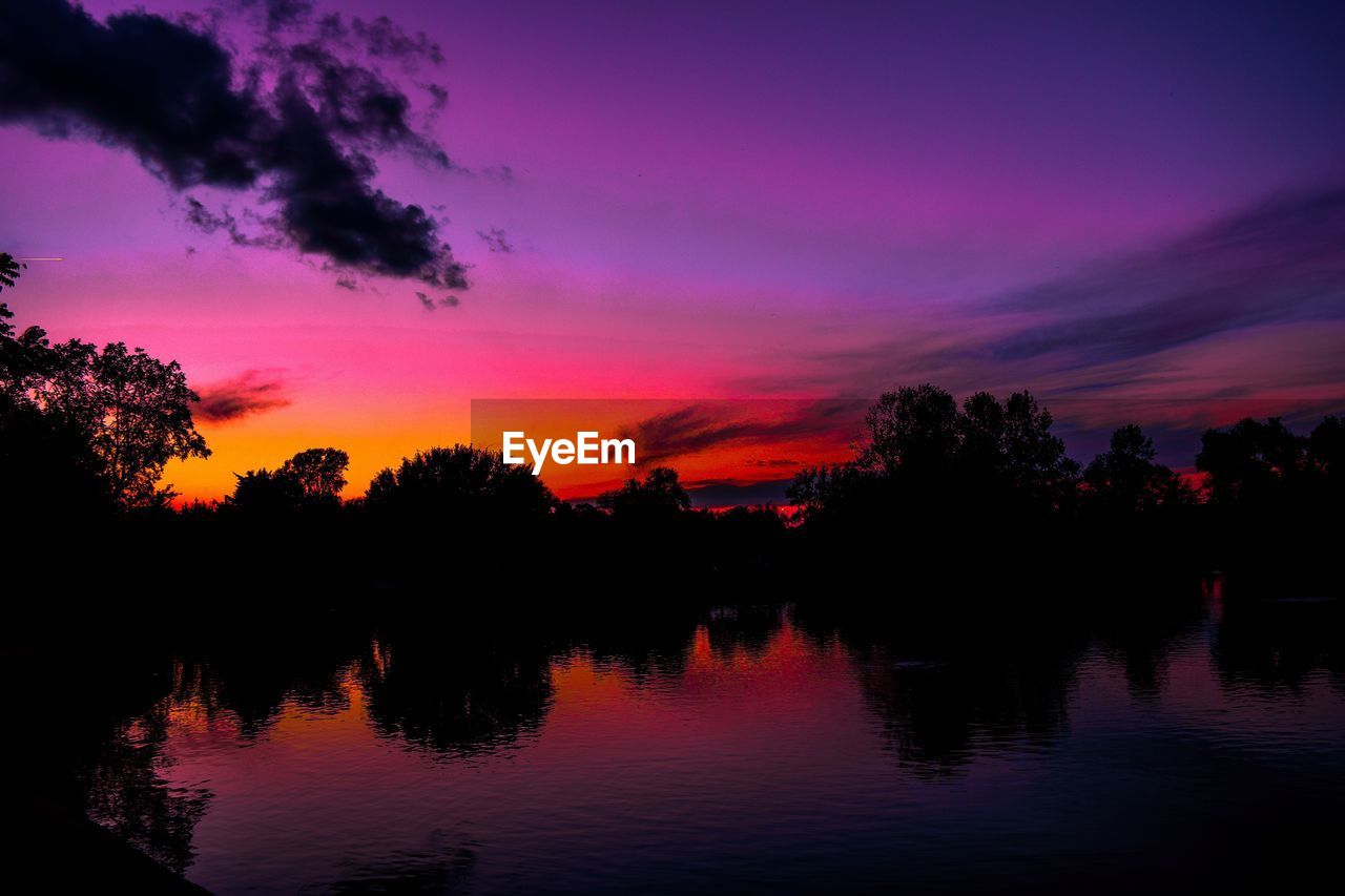 SUNSET OVER CALM LAKE