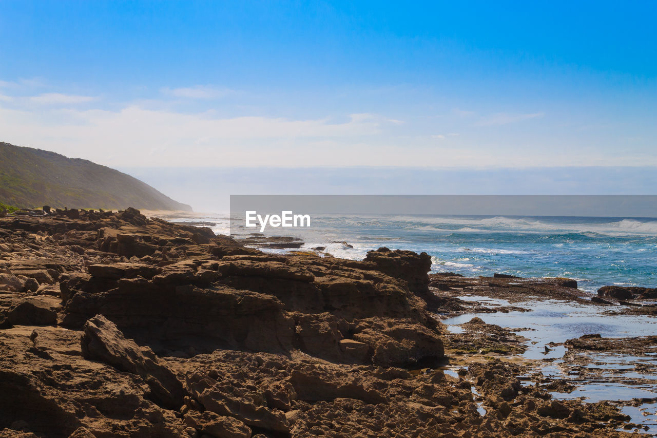 SCENIC VIEW OF SEA AND ROCK FORMATION AGAINST SKY