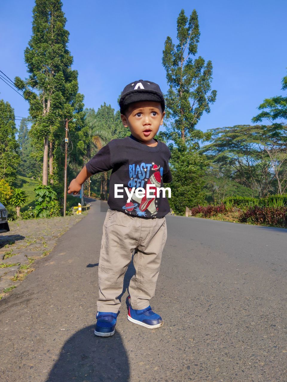 Portrait of boy standing on road
