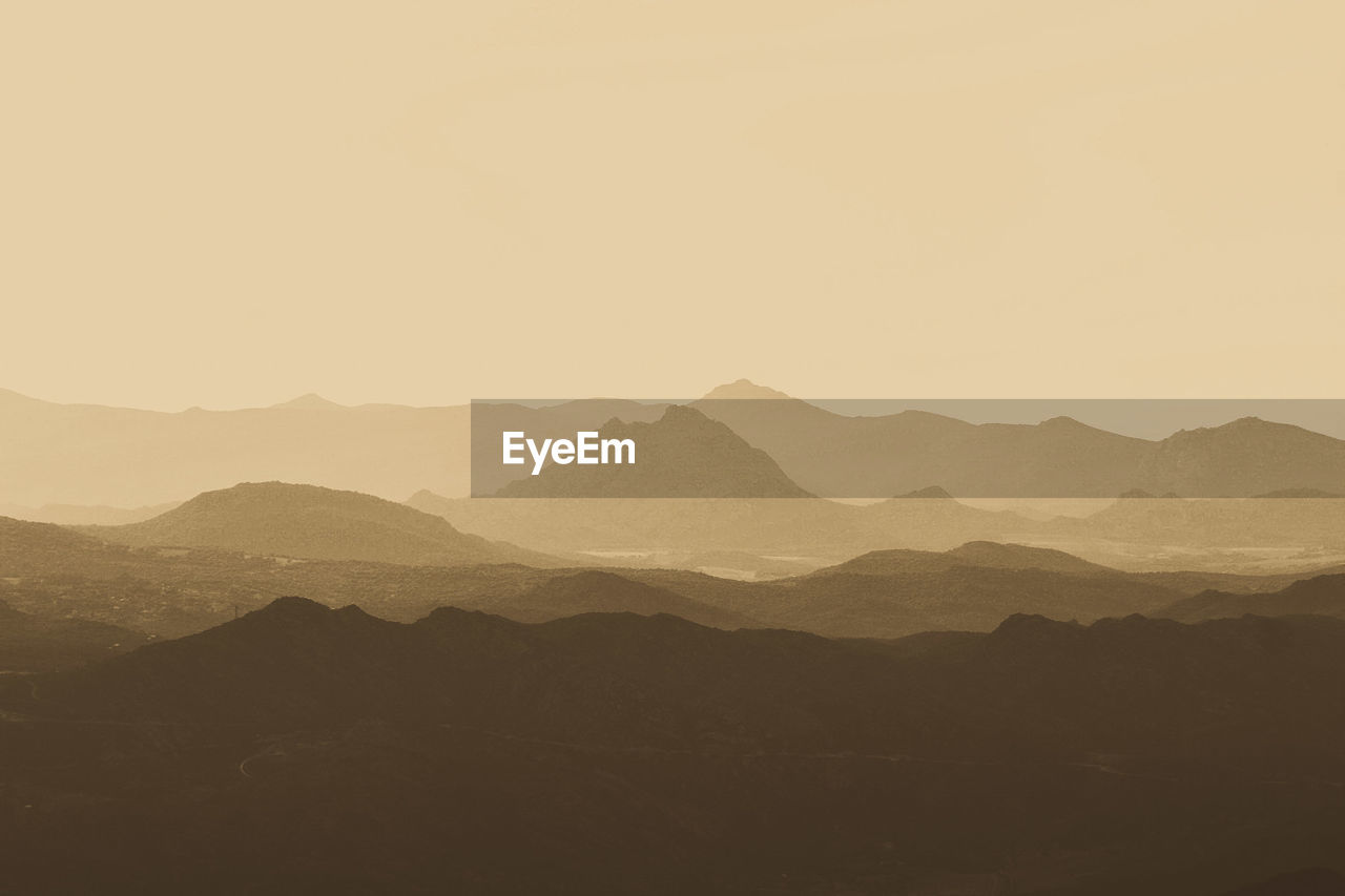 Scenic view of silhouette mountains against clear sky