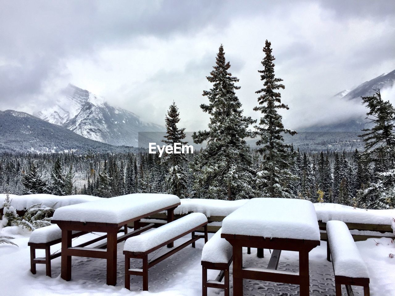 SNOW ON TABLE AGAINST MOUNTAIN