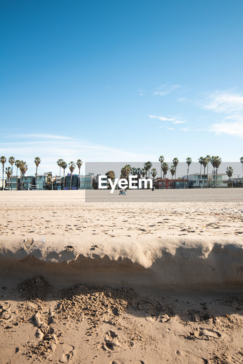 Scenic view of beach against blue sky