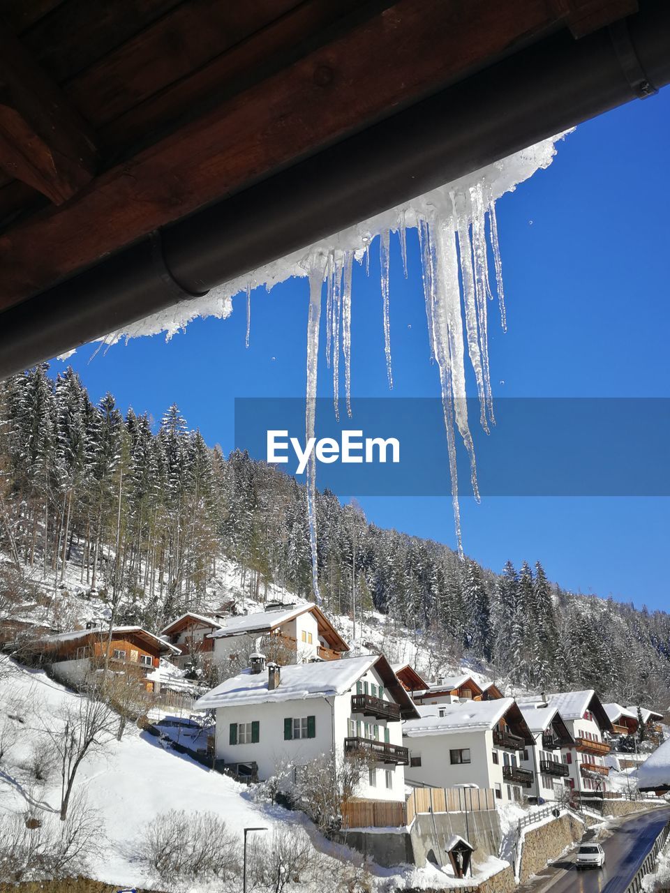 SNOW COVERED HOUSES AGAINST SKY