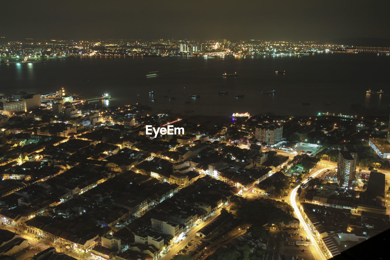 High angle view of illuminated city buildings at night