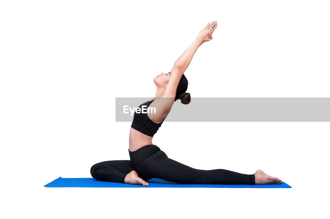 LOW ANGLE VIEW OF MAN WITH ARMS OUTSTRETCHED AGAINST WHITE BACKGROUND