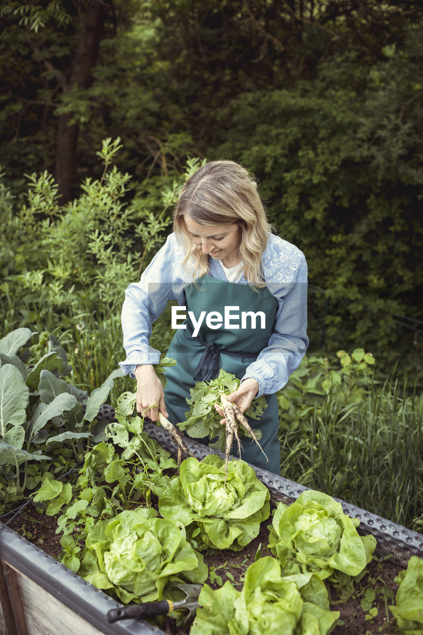 YOUNG WOMAN WITH VEGETABLES