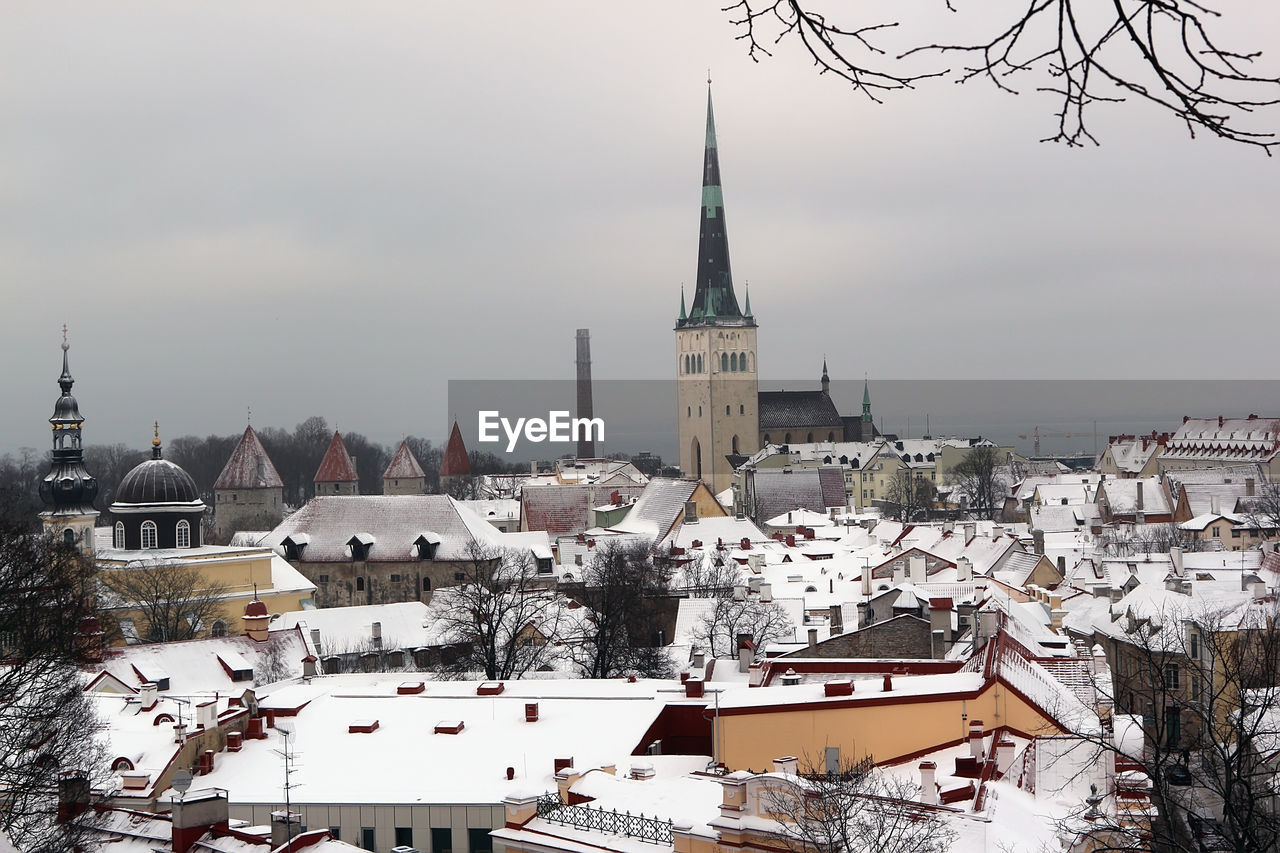 architecture, building exterior, built structure, winter, building, snow, cold temperature, city, place of worship, travel destinations, religion, nature, sky, cityscape, tower, roof, travel, tree, belief, town, tourism, history, high angle view, the past, spirituality, landscape, residential district, house, environment, no people, spire, outdoors, plant, worship, steeple, skyline, storm
