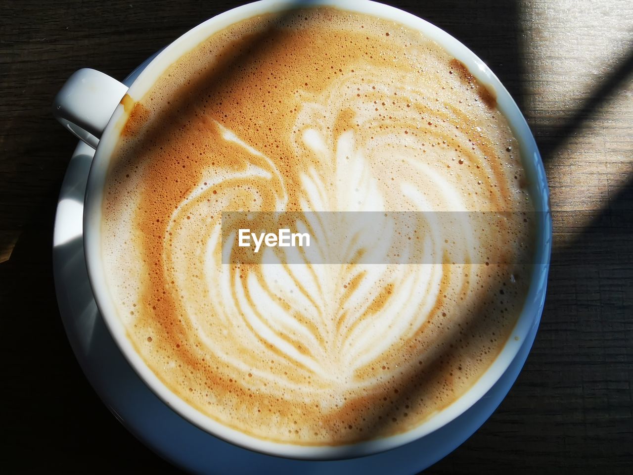 CLOSE-UP OF COFFEE CUP ON TABLE