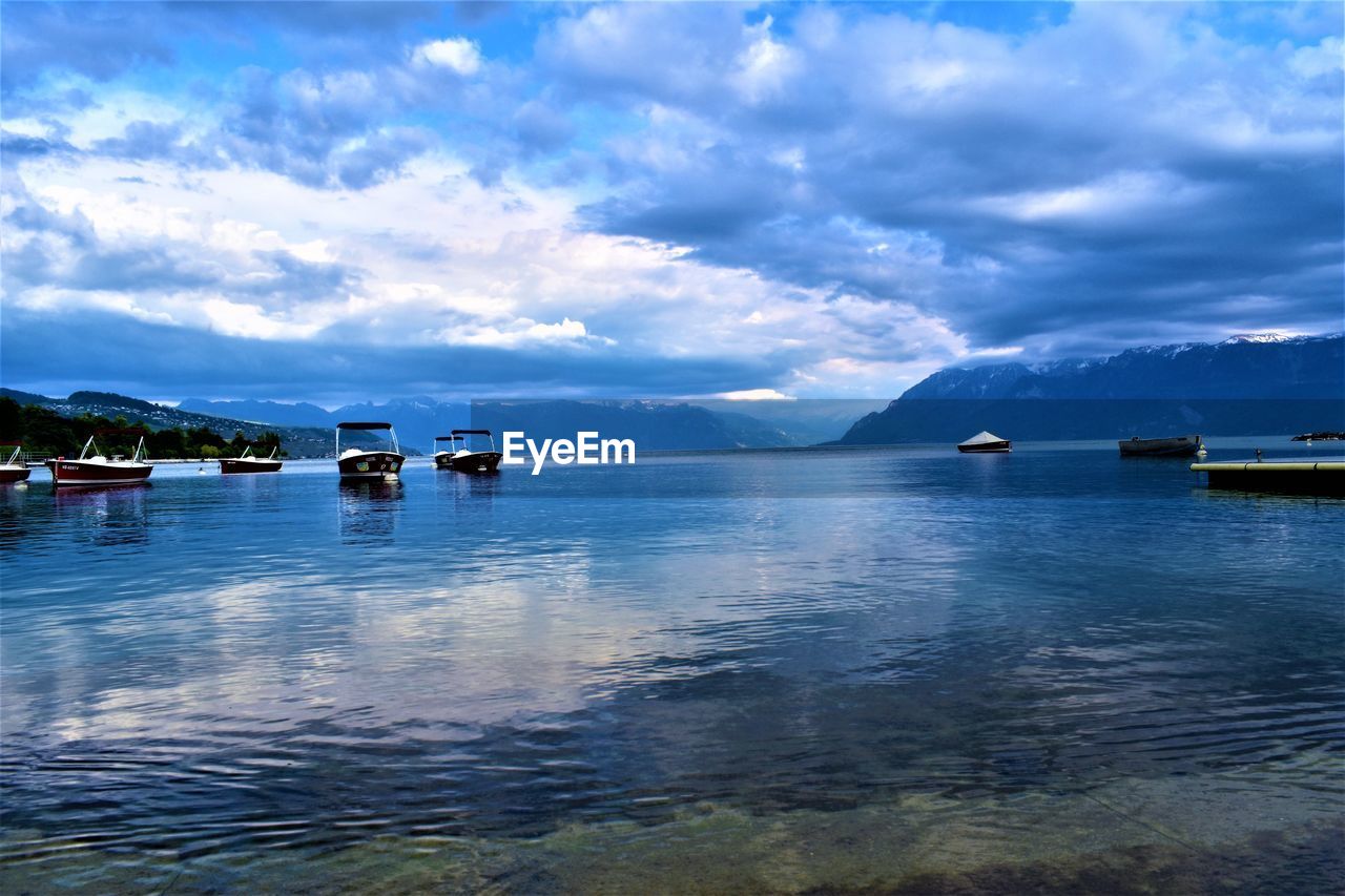 Boats in sea against sky