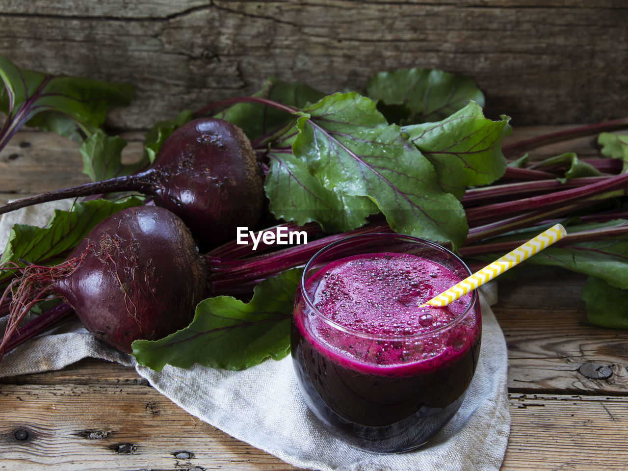 Fresh smoothie squeezed  beetroot juice in a glass on a wooden surface  healthy eating, detox, diet
