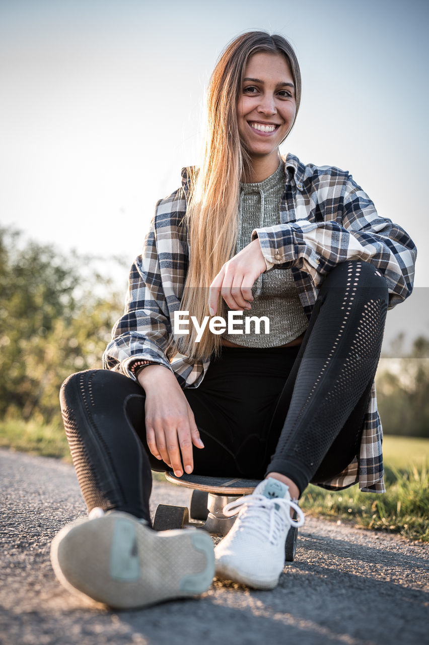 Portrait of smiling woman sitting outdoors