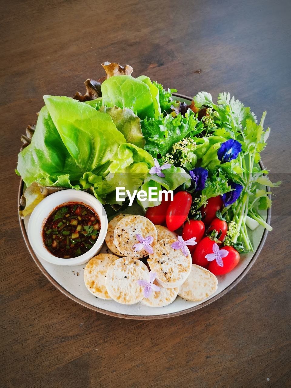 food, food and drink, healthy eating, vegetable, wellbeing, freshness, salad, dish, lettuce, bowl, table, no people, fruit, indoors, tomato, high angle view, variation, meal, plate, still life, studio shot, cuisine, lunch, fast food, produce, salad bowl, wood, directly above